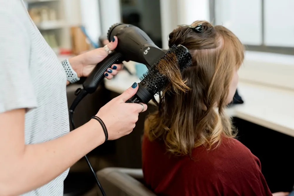 Stylist creating an artful haircut at Urban Salon in warm natural lighting