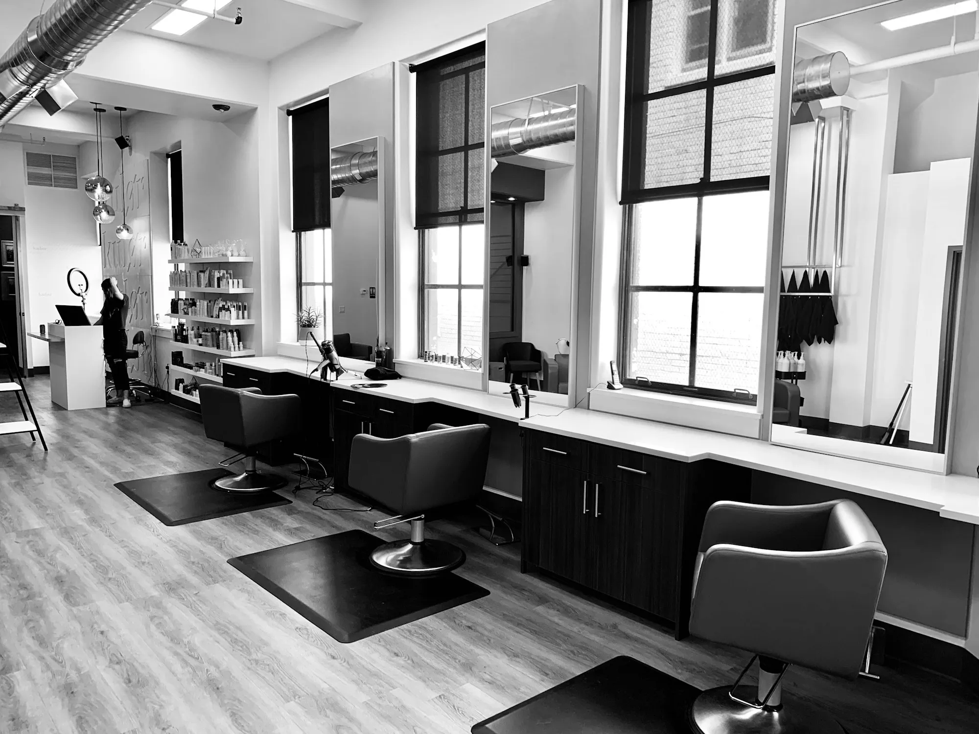 Urban Unisex Hair Salon luxury interior with warm gold illumination and modern styling chairs